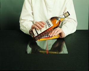 cashier scanning candy for whiskey